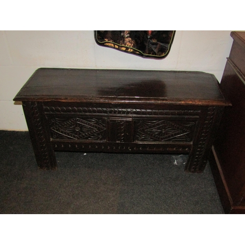 1034 - A 17th Century style oak coffer, two panel front, stile legs, 46cm high x 96cm wide x 33cm deep