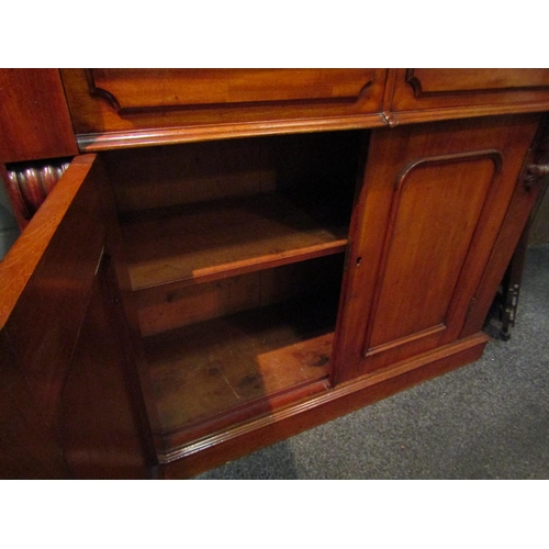 1038 - A Victorian mahogany bookcase, two drawer over two door base, missing some veneer, 226cm high x 107c... 