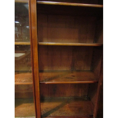 1038 - A Victorian mahogany bookcase, two drawer over two door base, missing some veneer, 226cm high x 107c... 