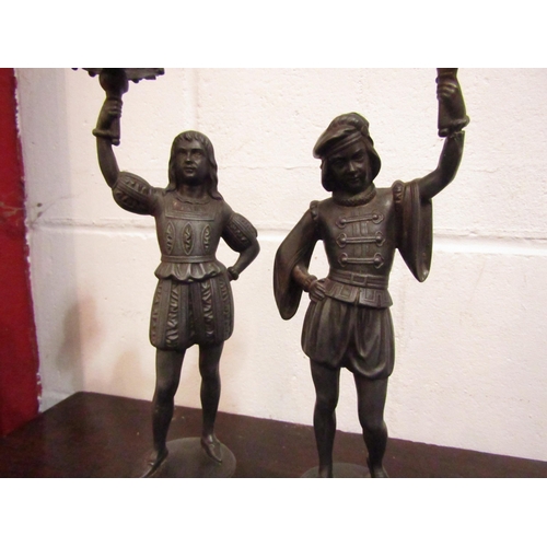 1058 - A pair of spelter figural candlesticks, scrolled foliate base, 36cm tall approx.  (E)  £20-30