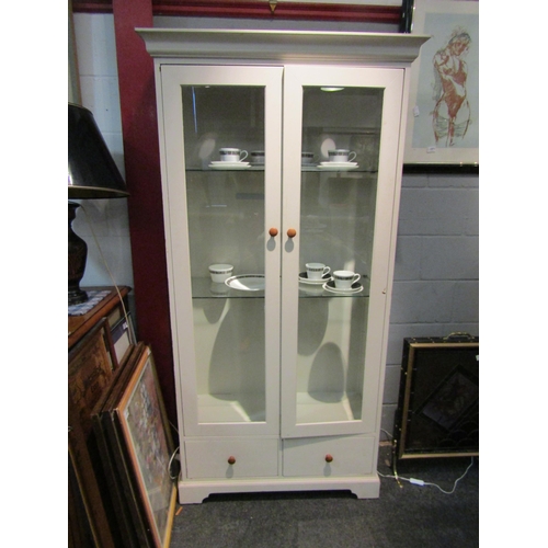 1073 - A painted Victorian style two door bevel glazed bookcase over two drawers on a plinth base, 186.5cm ... 