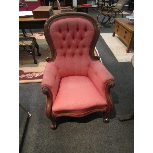 1084 - A Victorian mahogany button back armchair with scroll arms and feet  (E)  £50-80