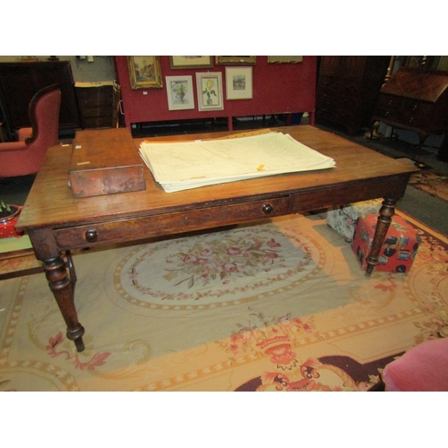 1111 - A Victorian mahogany schoolmaster’s table with two end drawers and one side drawer, on turned legs, ... 