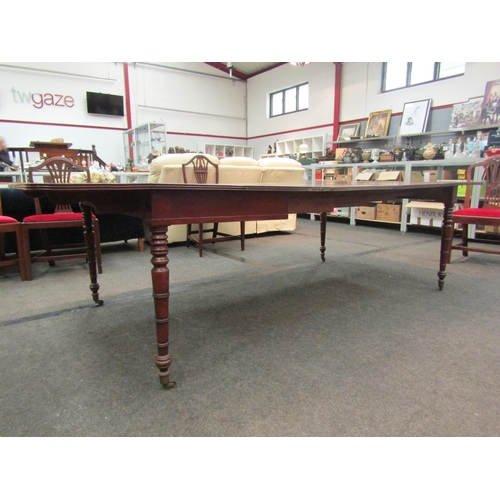 1135 - A Victorian extending dining table with three extra leaves on turned legs to castors, 73cm high x 26... 