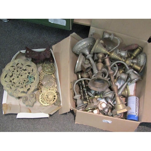 1140 - A box containing assorted brass and metal candlesticks, horse brasses and trivet etc.