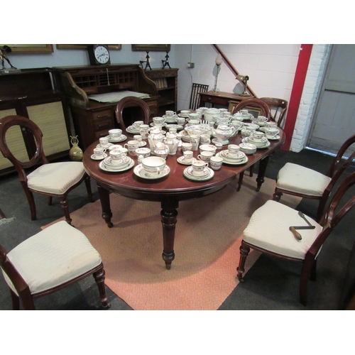 1019 - A Spillmans & Co., London, Edwardian mahogany circular extending dining table with fluted legs to br... 