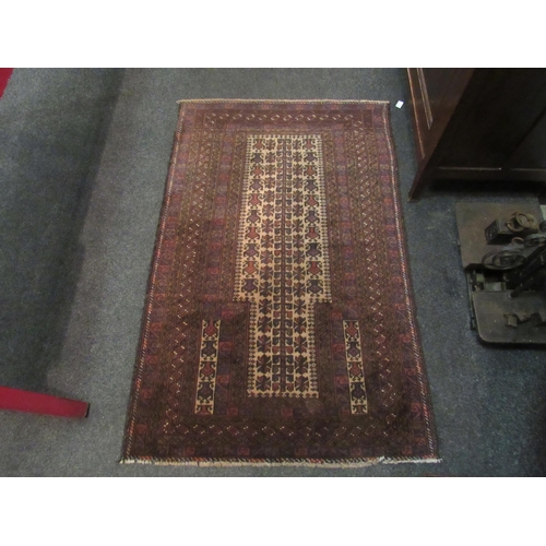 1061 - A red ground geometric design rug with multiple borders, 140cm x 90cm