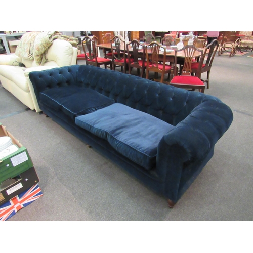 1138 - An Edwardian chesterfield sofa with deep blue velvet upholstery, a/f