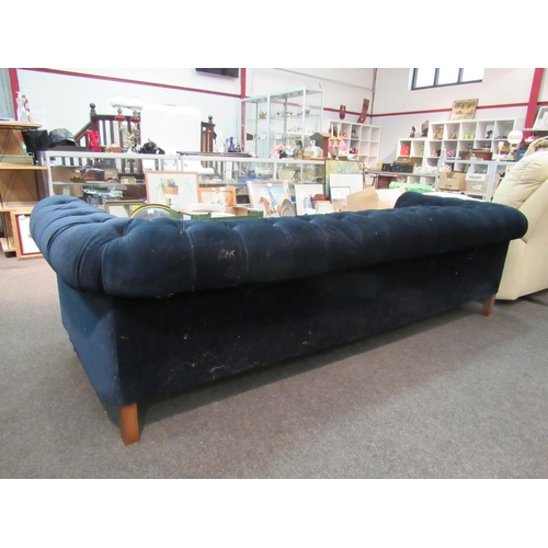 1138 - An Edwardian chesterfield sofa with deep blue velvet upholstery, a/f