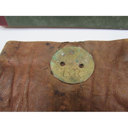 7029 - An unused LNER ledger book and a leather cash bag with brass closing disc stamped B.R, home/destinat... 