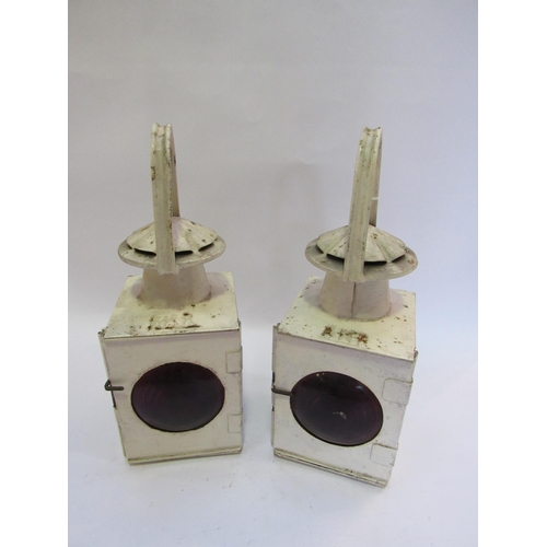 7259 - A pair of white painted square form handlamps with red bullseye lenses, burners and resevoirs