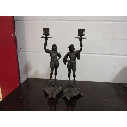 1054 - A pair of spelter figural candlesticks, scrolled foliate base, 36cm tall approx.