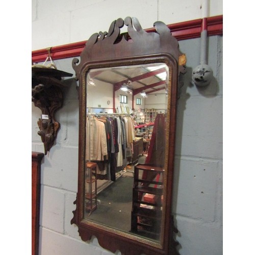 1064 - A 19th Century mahogany shaped wall mirror with scroll detail, moulded and gilt border, areas of res... 