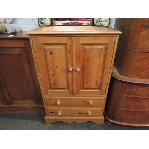 1036 - A country pine cupboard, the two doors over two drawers, 115cm high x 76cm wide x 45cm deep