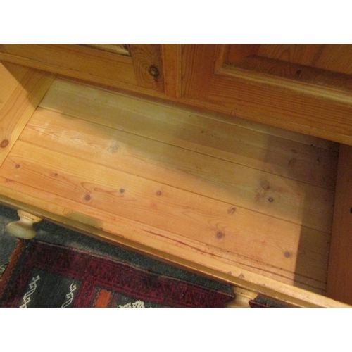 1036 - A country pine cupboard, the two doors over two drawers, 115cm high x 76cm wide x 45cm deep