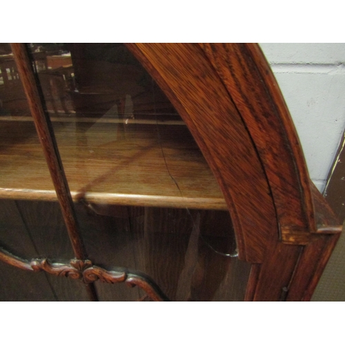 1040 - A 20th Century oak dome top china display cabinet, crack to glass, 140cm high x 94cm wide x 32cm dee... 