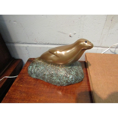 1043 - A Foot's Artworks, Australia 2006 cold cast bronze of a seal, No. 93/99, 21cm long x 14cm deep x 16.... 