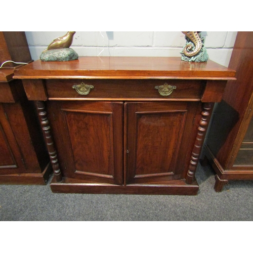 1045 - A Victorian walnut sideboard, the recessed drawer over two door cupboard, spindle detail, plinth bas... 