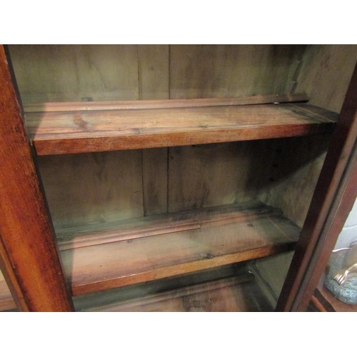 1046 - A Victorian mahogany full height bookcase, glazed top over single drawer and two door cupboard, plin... 