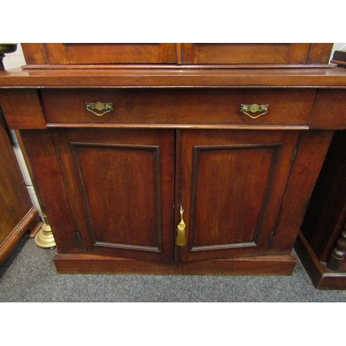 1046 - A Victorian mahogany full height bookcase, glazed top over single drawer and two door cupboard, plin... 