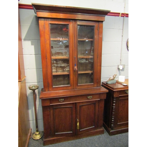 1046 - A Victorian mahogany full height bookcase, glazed top over single drawer and two door cupboard, plin... 