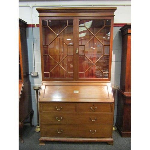 1048 - An early 20th Century mahogany bureau bookcase with fitted pigeon hole and drawer interior, two shor... 