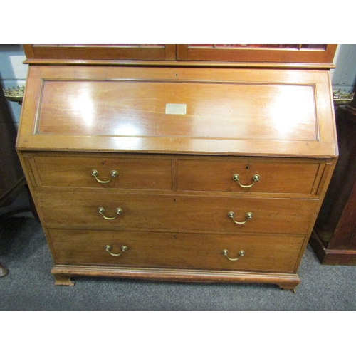 1048 - An early 20th Century mahogany bureau bookcase with fitted pigeon hole and drawer interior, two shor... 