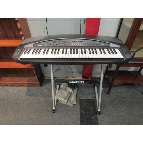 1062 - An electronic Casio CT-X1 keyboard, complete with stand and power supply