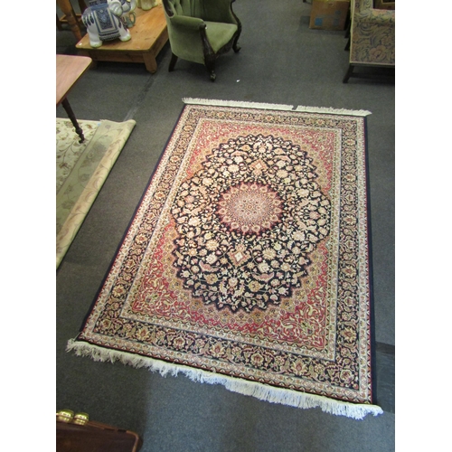 1544 - A blue ground machine woven rug with floral pattern, multiple borders and tasselled ends, 223cm x 16... 