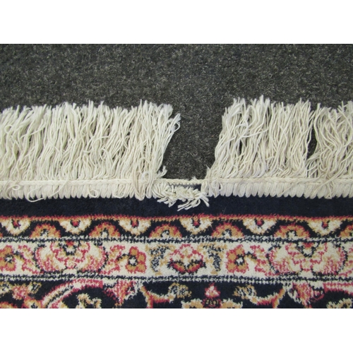 1544 - A blue ground machine woven rug with floral pattern, multiple borders and tasselled ends, 223cm x 16... 