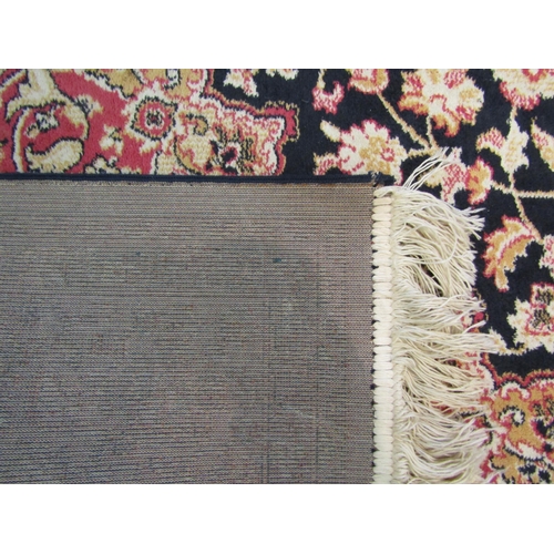 1544 - A blue ground machine woven rug with floral pattern, multiple borders and tasselled ends, 223cm x 16... 