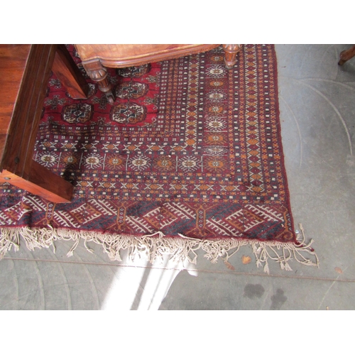 2235 - A red and blue ground rug, tasselled ends   345 X 285cm