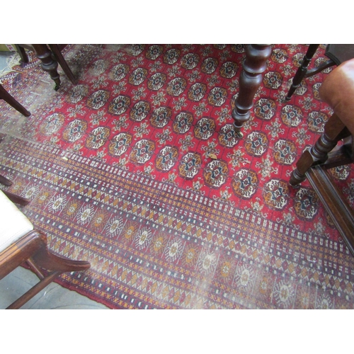 2235 - A red and blue ground rug, tasselled ends   345 X 285cm