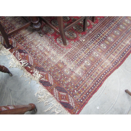 2235 - A red and blue ground rug, tasselled ends   345 X 285cm