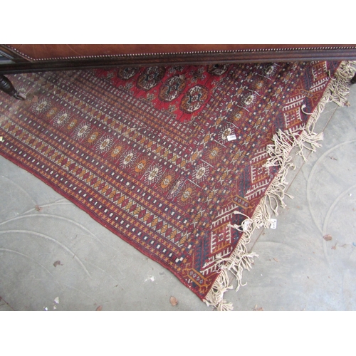 2235 - A red and blue ground rug, tasselled ends   345 X 285cm