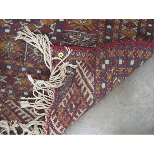 2235 - A red and blue ground rug, tasselled ends   345 X 285cm