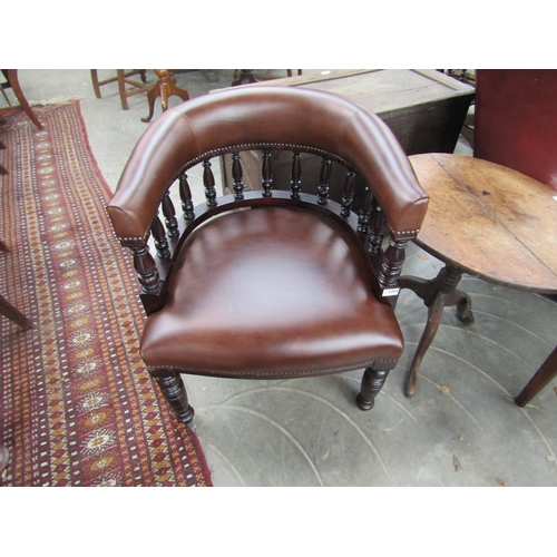 2238 - A Victorian mahogany framed desk armchair upholstered in brown studded leather