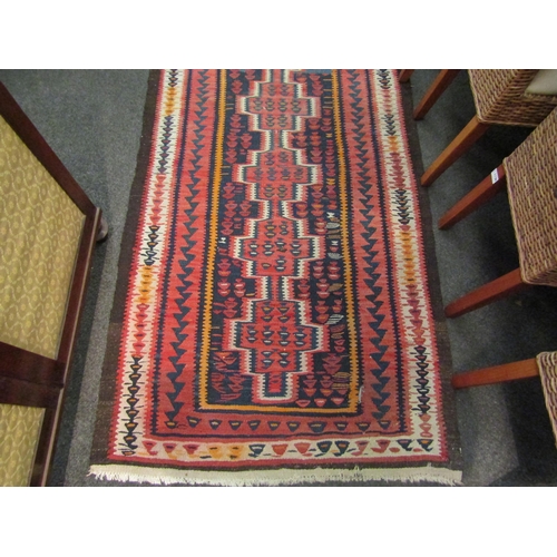 1028 - A cotton kilim runner rug in rust and pink colours, 376cm x 105cm