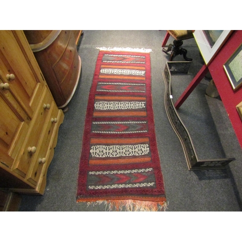 1029 - A kilim runner rug, red ground, tassels a/f, 90cm x 70cm