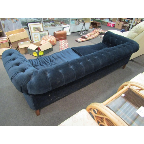 1153 - An Edwardian Chesterfield sofa with deep blue velvet upholstery, a/f