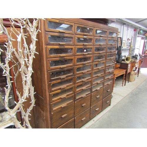 2075 - A large haberdasher's shop bank of 40 drawers, 32 glazed over 8 deeper drawers 188w x 50d x 194cm ta... 