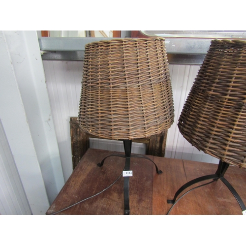 2143 - A wrought iron and wicker table lamp