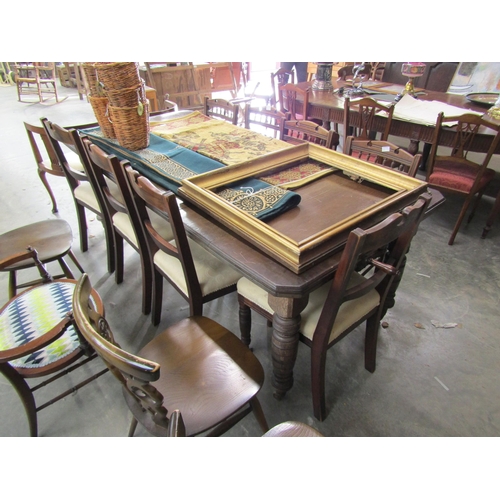 2173 - An Edwardian mahogany extending dining table on castors, with two extra leaves   (E) £40-60