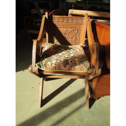 2191 - A carved X- frame chair with cushion