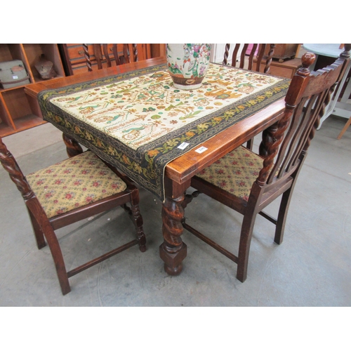 2243 - A large oak draw leaf dining table and four chairs