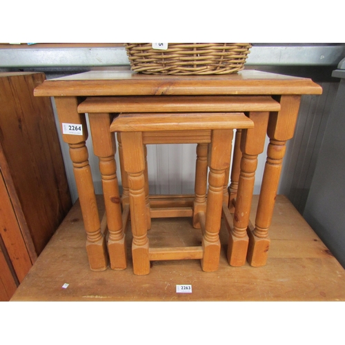 2264 - A modern pine nest of three fitting tables