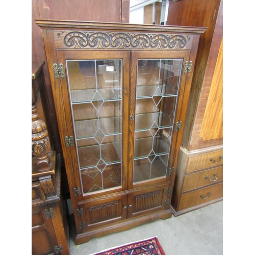 2335 - An old charm oak and glazed display cabinet