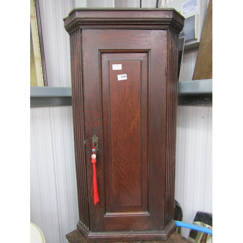 2386 - An oak corner cupboard with reeded sides