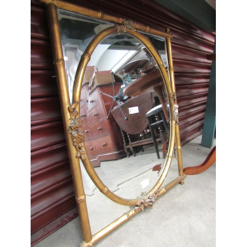 2443 - A highly decorative 19th Century bamboo effect mirror with oval mirror plate, some damage to frame