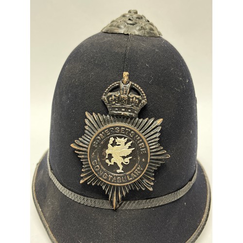 9264 - A Somersetshire Constabulary Police helmet, rose top, George crown badge, liner a/f